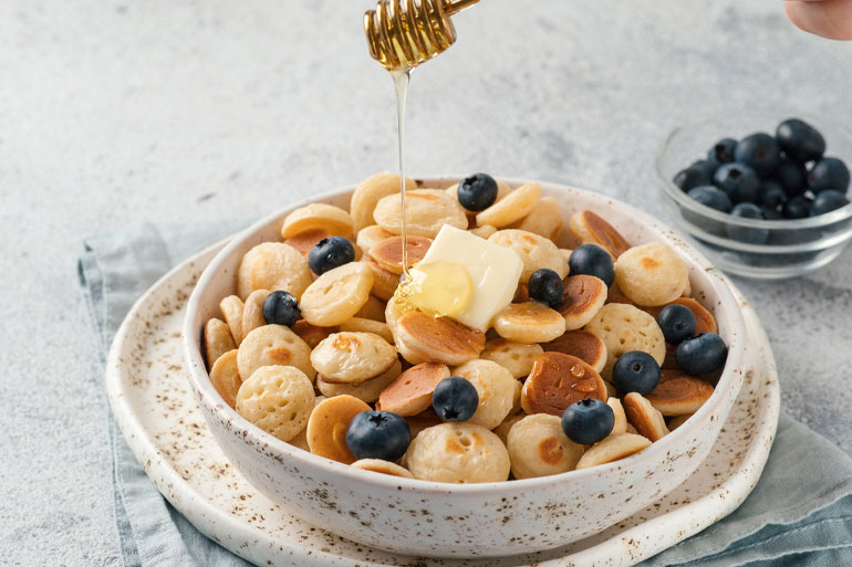 Pancake Cereal in a bowl with blueberries lifestyle image