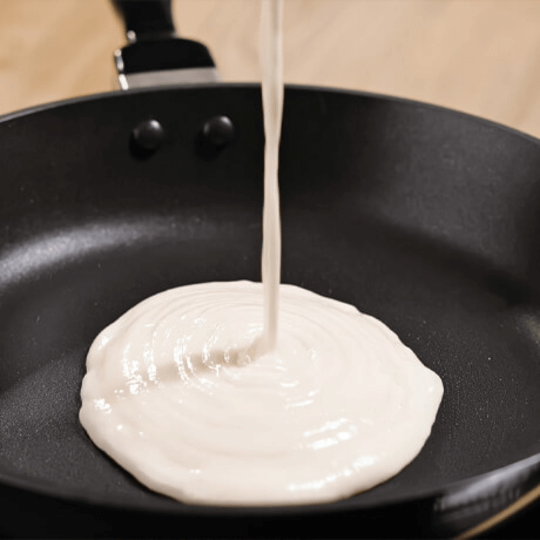 Pancake mix poured onto a pan