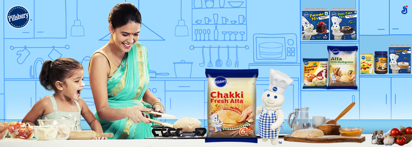 Woman and young child cooking in a kitchen with a small doughboy in the corner and a Chakki Fresh Atta packshot