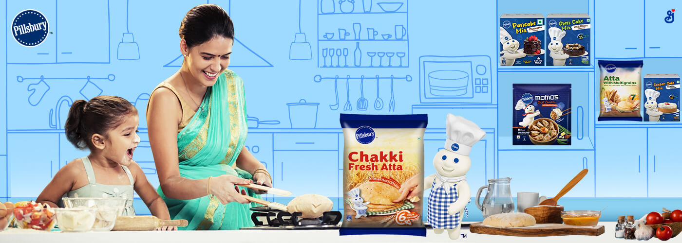 Woman and young child cooking in a kitchen with a small doughboy in the corner and a Chakki Fresh Atta & Momos packshots