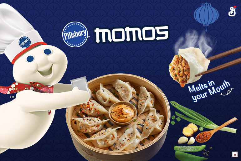 The Pillsbury Doughboy coming out of the side pouring Magic Momo Masala seasoning on a bowl of Momos with the text reading, "Momos, melts in your mouth"