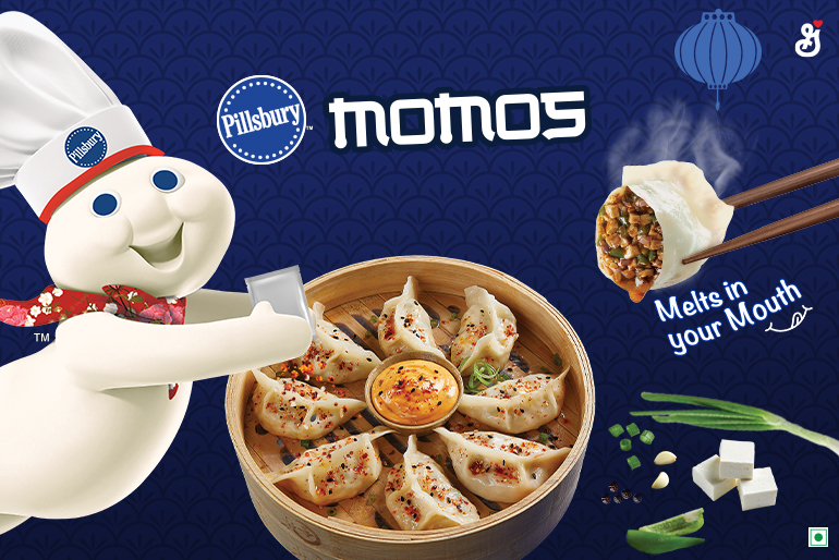 The Pillsbury Doughboy coming out of the side pouring Magic Momo Masala seasoning on a bowl of Chilli Paneer Momos with the text reading, "Momos, melts in your mouth"