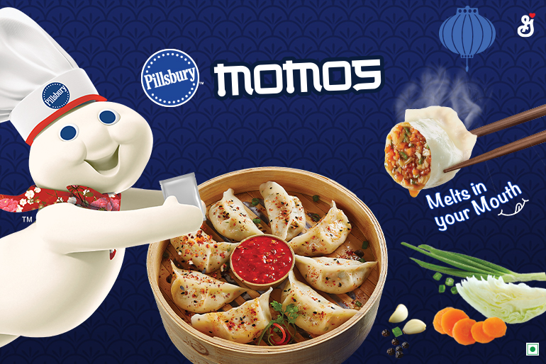 The Pillsbury Doughboy coming out of the side pouring Magic Momo Masala seasoning on a bowl of Veg Delight Momos with the text reading, "Momos, melts in your mouth"